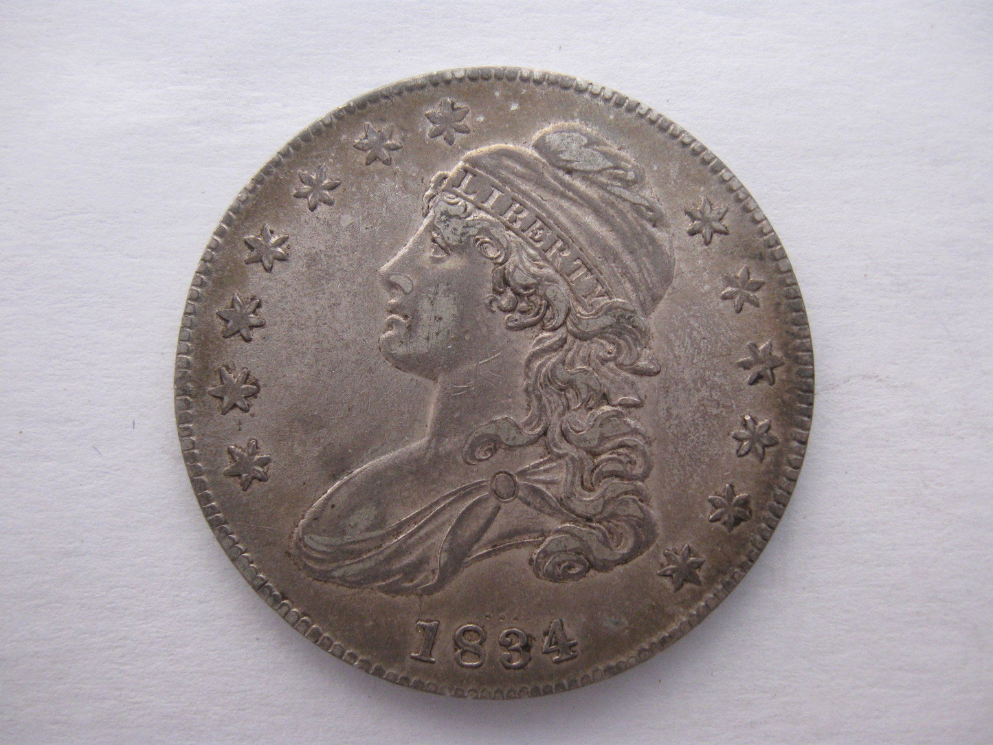 1834 Capped Bust Half Dollar. AU-50 | Of Coins & Crystals