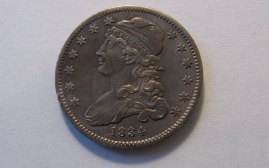 1834 Capped Bust Quarter.  AU-50 | Of Coins & Crystals