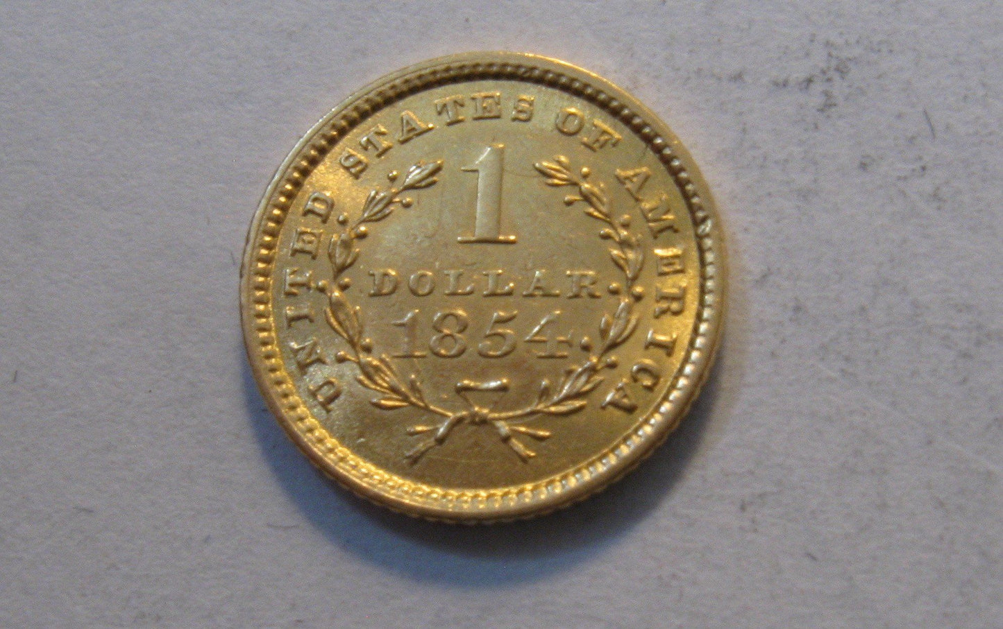 1854 Liberty Head Gold Dollar.  MS-62 | Of Coins & Crystals