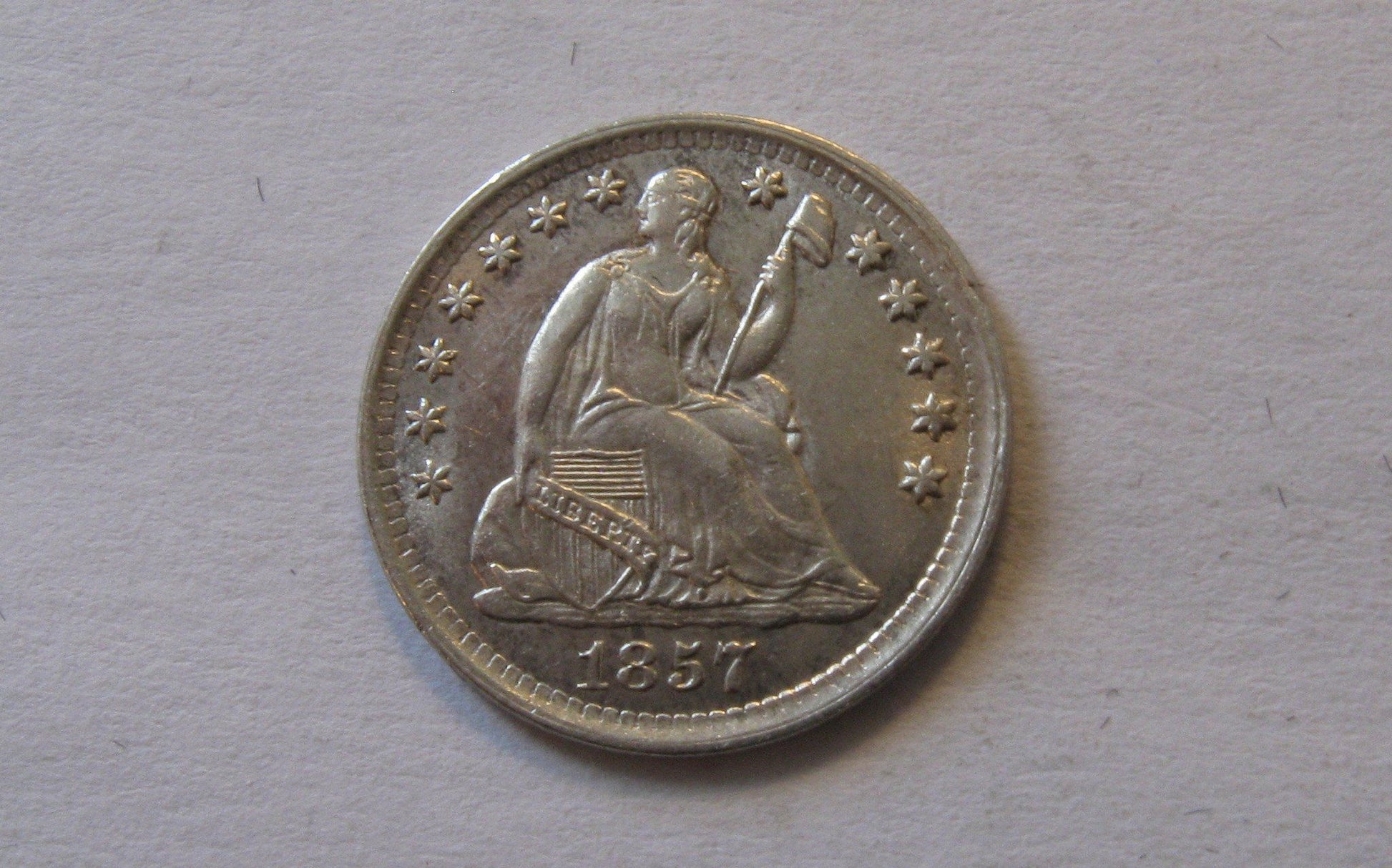 1857 Seated Liberty Half Dime.  AU-50 | Of Coins & Crystals