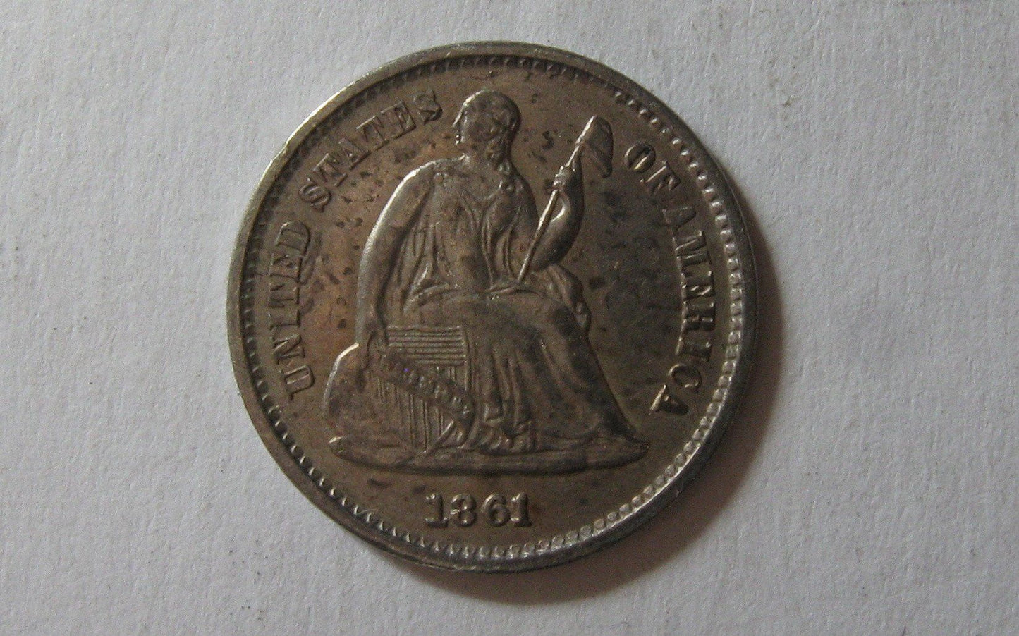 1861/0 Seated Liberty Half Dime. AU-58 | Of Coins & Crystals