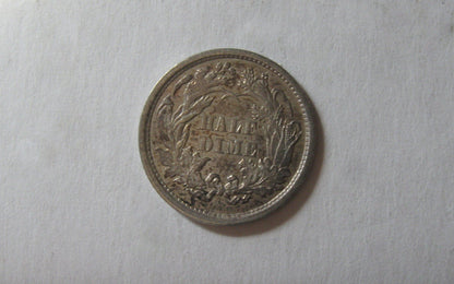 1861/0 Seated Liberty Half Dime. AU-58 | Of Coins & Crystals